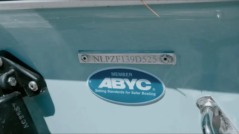 Slide: The Image of 2025 Tidewater 210 LXF boat with ABYC safety certification label. - 14