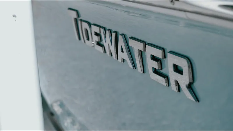 Slide: The Image of 2025 Tidewater 210 LXF boat logo on sleek exterior surface. - 17