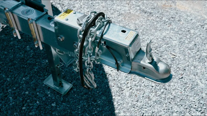 Slide: The Image of Trailer hitch of 2025 Tidewater 210 LXF boat on gravel surface. - 21