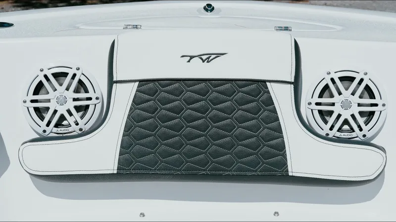 Slide: The Image of 2025 Tidewater 210 LXF boat interior with speakers and stylish upholstery design. - 23