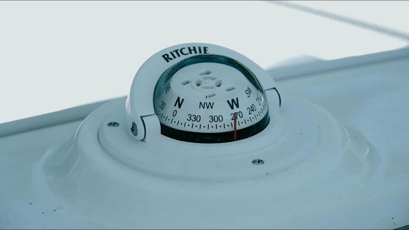 Slide: The Image of Compass on 2025 Tidewater 210 LXF boat, displaying cardinal directions. - 25