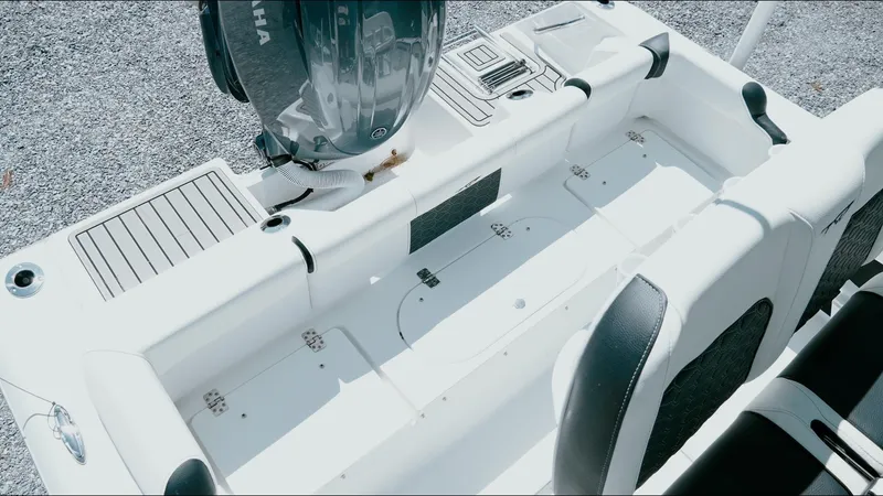 Slide: The Image of 2025 Tidewater 210 LXF boat interior with Yamaha engine, showcasing seating and storage areas. - 26
