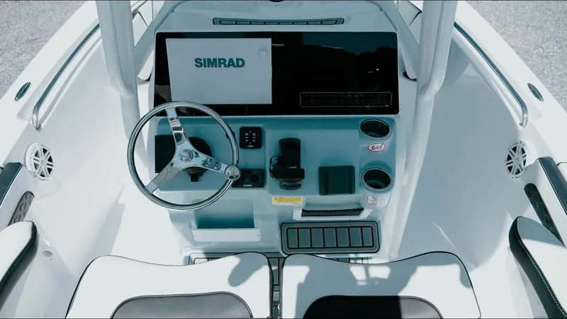 Slide: The Image of 2025 Tidewater 210 LXF boat console with Simrad display and steering wheel. - 28
