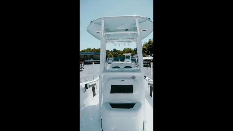 Slide: The Image of 2025 Tidewater 210 LXF boat, center console view, outdoors on a sunny day. - 29