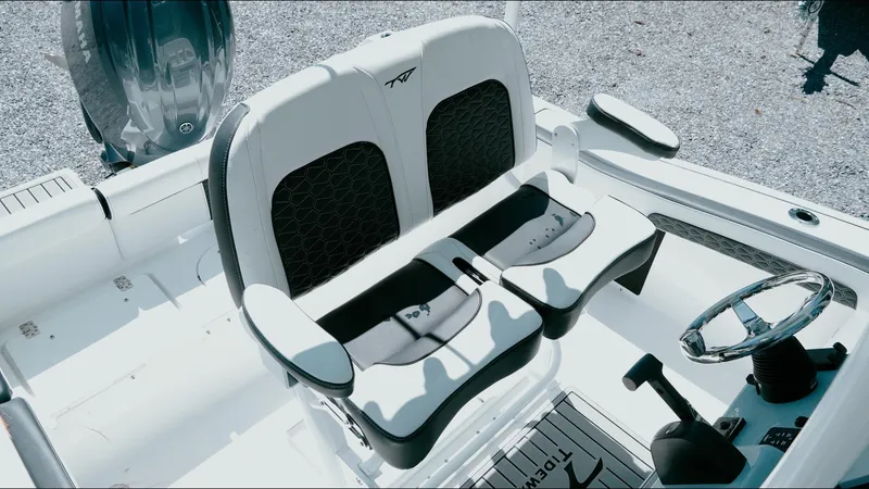 Slide: The Image of 2025 Tidewater 210 LXF boat interior with dual seating and steering wheel. - 30