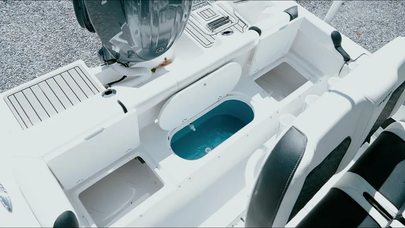 Slide: The Image of 2025 Tidewater 210 LXF boat interior with open storage compartments and seating. - 31
