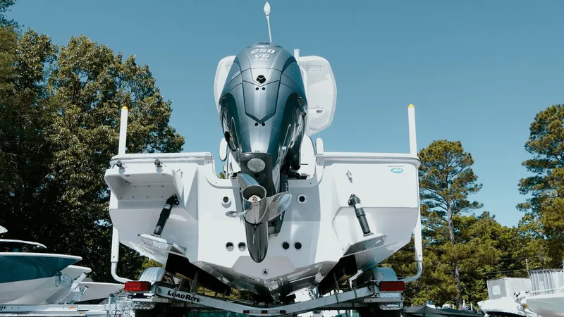 Slide: The Image of 2025 Tidewater 2210 Carolina Bay boat on trailer, rear view with outboard motor. - 11