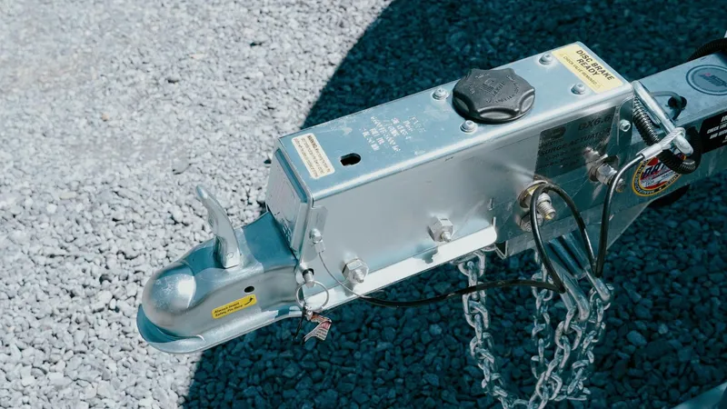 Slide: The Image of Trailer hitch of 2025 Tidewater 2210 Carolina Bay on gravel surface. - 12