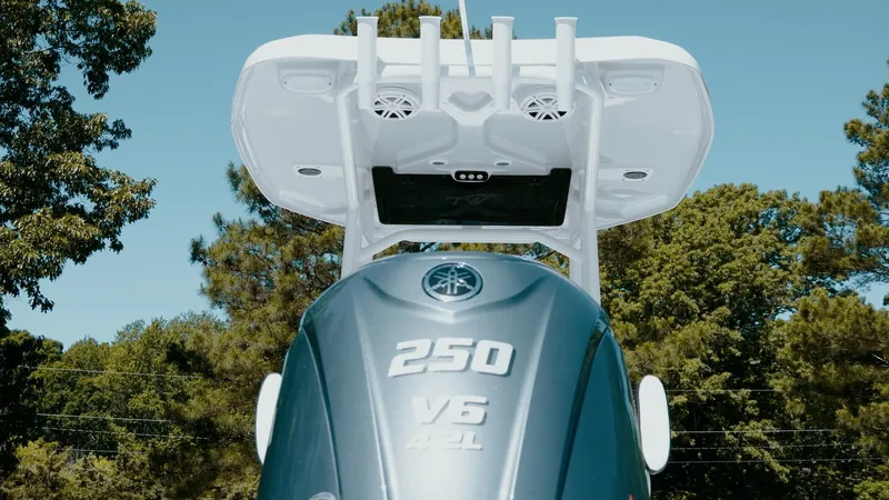 Slide: The Image of 2025 Tidewater 2210 Carolina Bay boat with Yamaha 250 V6 engine, outdoor setting. - 14