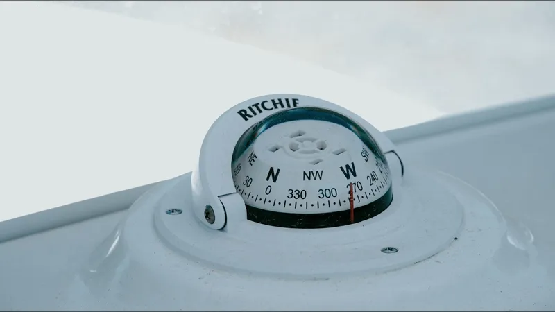 Slide: The Image of Compass on 2025 Tidewater 2210 Carolina Bay boat, displaying cardinal directions. - 20