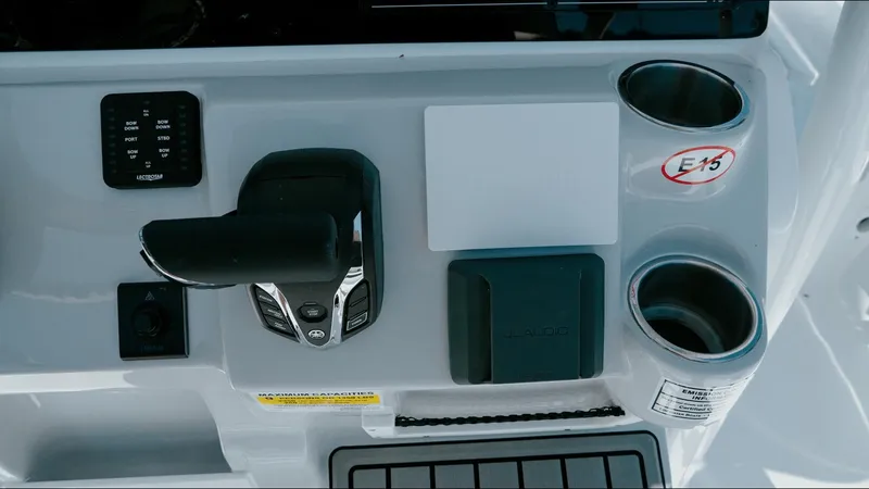 Slide: The Image of Control panel of 2025 Tidewater 2210 Carolina Bay boat with cup holders and throttle. - 22