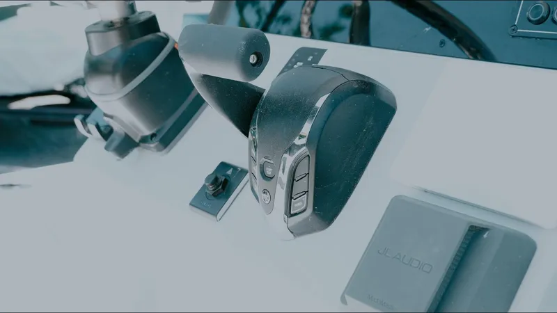 Slide: The Image of Control panel of 2025 Tidewater 2210 Carolina Bay boat, featuring modern throttle and switches. - 23