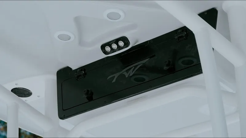 Slide: The Image of 2025 Tidewater 2210 Carolina Bay boat console with storage compartment and LED lights. - 24