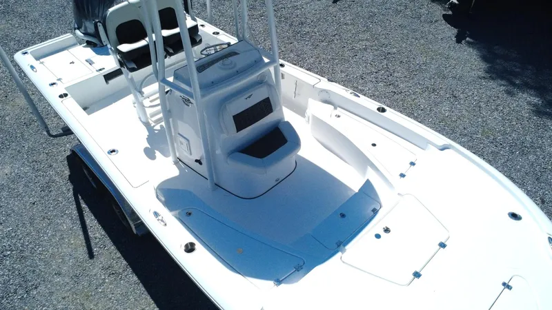 Slide: The Image of 2025 Tidewater 2210 Carolina Bay boat, white deck, center console, on gravel surface. - 6