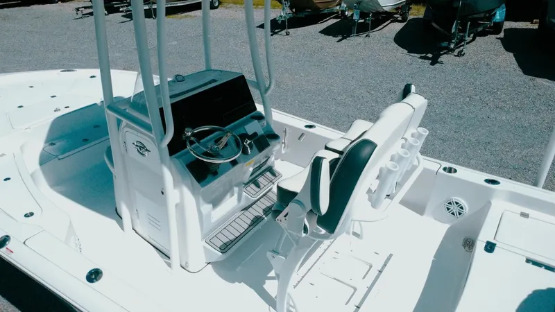 Slide: The Image of 2025 Tidewater 2210 Carolina Bay boat interior with steering console and seating. - 8