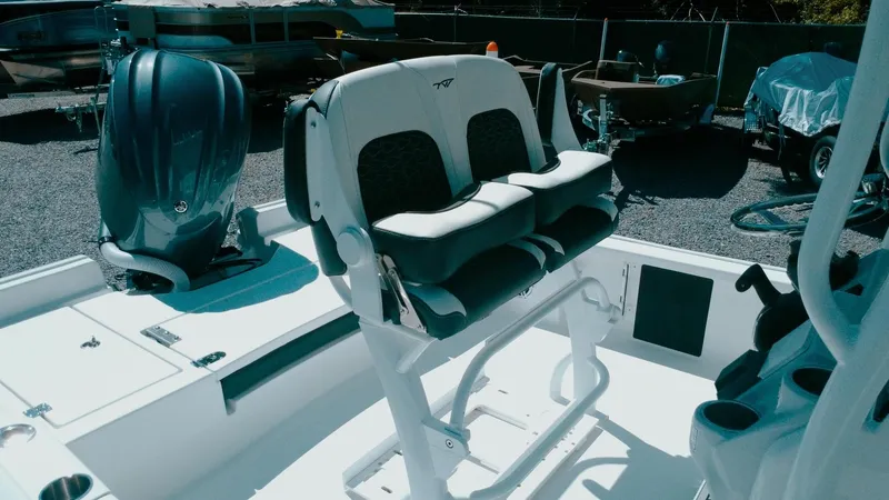 Slide: The Image of 2025 Tidewater 2210 Carolina Bay boat interior with dual seating and motor. - 9