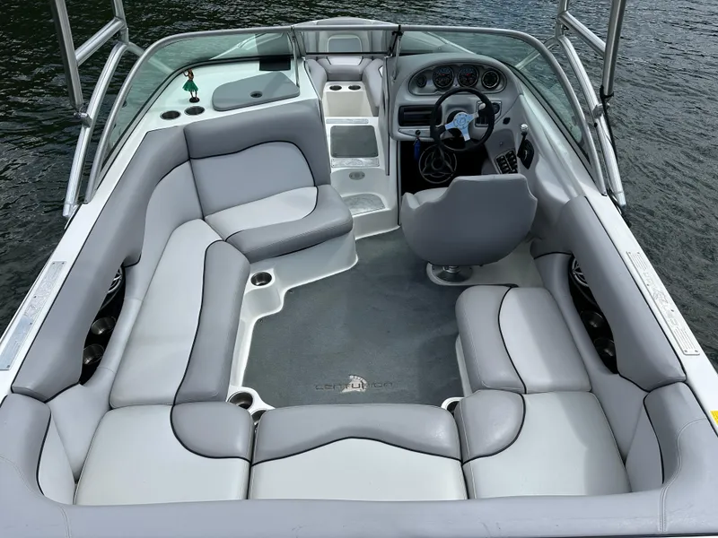 Slide: The Image of 2007 Centurion Avalanche boat interior with gray seating and steering wheel, on calm water. - 10
