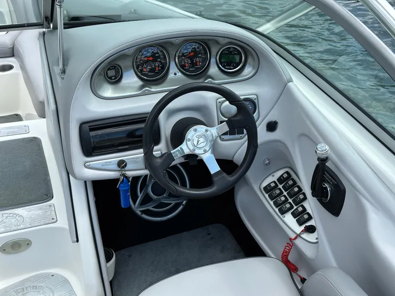 Slide: The Image of 2007 Centurion Avalanche boat dashboard with steering wheel and control panel. - 13