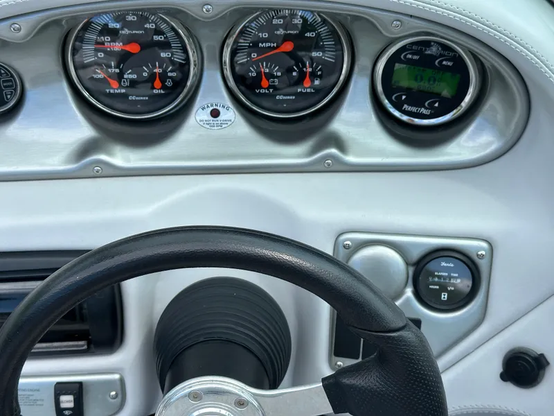 Slide: The Image of Dashboard of a 2007 Centurion Avalanche boat with gauges and steering wheel. - 14
