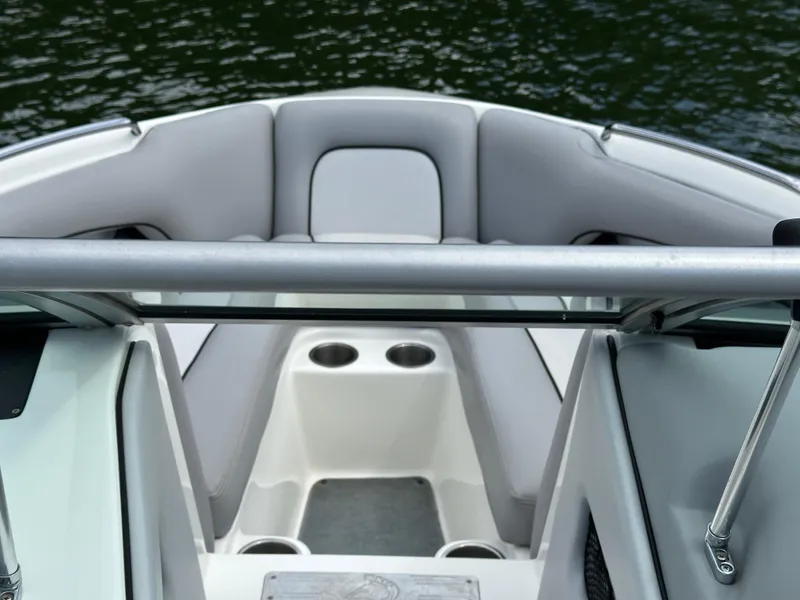 Slide: The Image of 2007 Centurion Avalanche boat interior with gray seating and cup holders on a calm water background. - 15