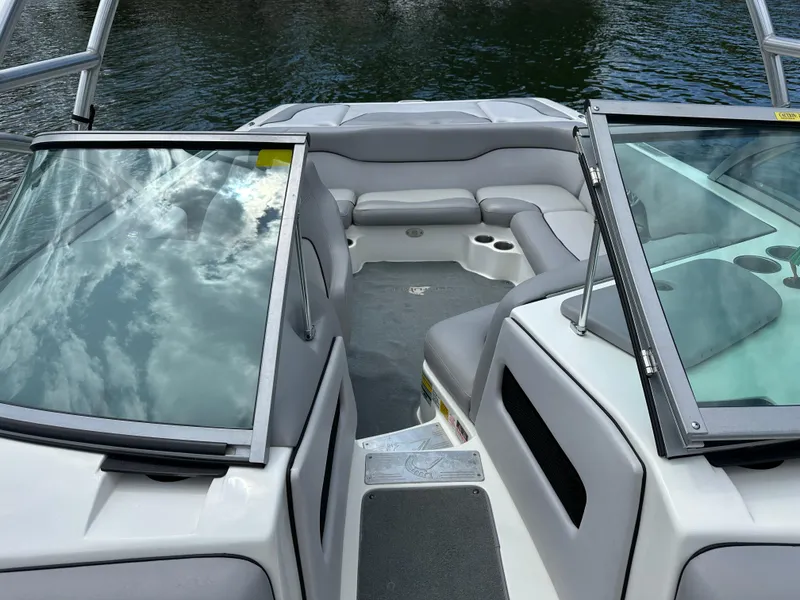 Slide: The Image of 2007 Centurion Avalanche boat interior with gray seating and open windshield on calm water. - 17