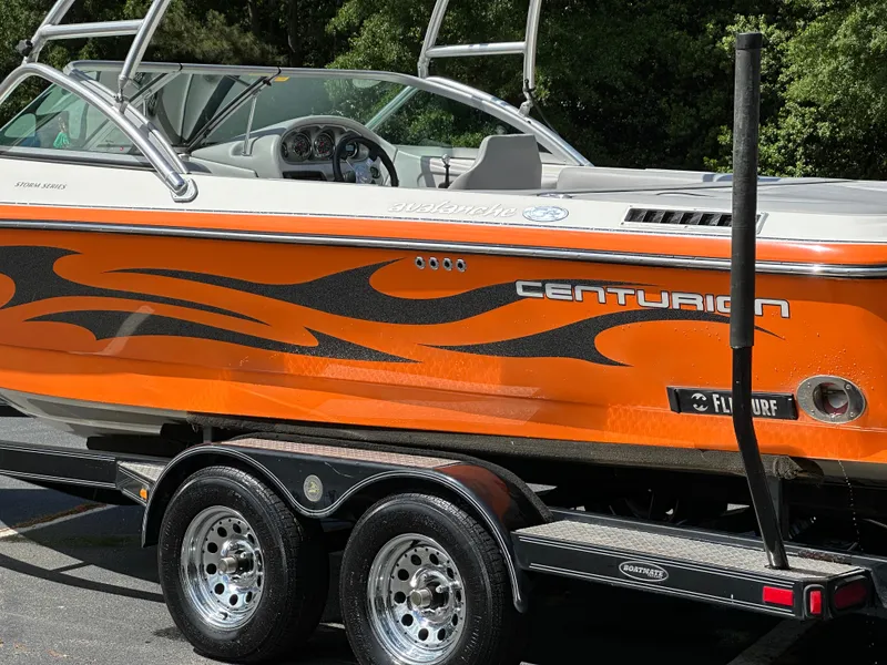 Slide: The Image of Orange 2007 Centurion Avalanche boat on trailer with flame graphics and sleek design. - 23