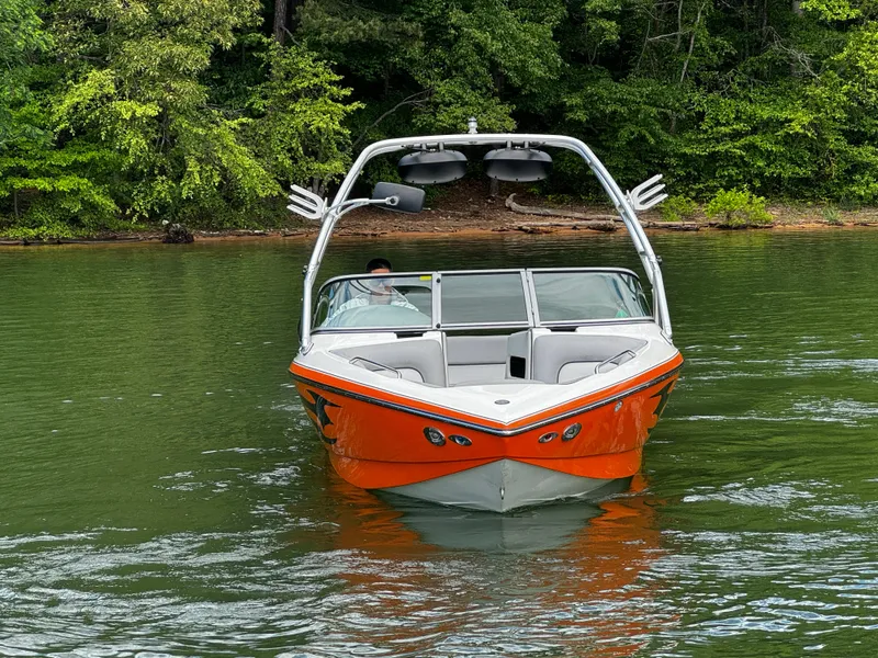 Slide: The Image of 2007 Centurion Avalanche boat on a lake, surrounded by lush greenery. - 3