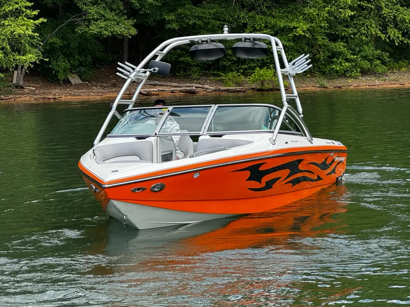 Slide: The Image of 2007 Centurion Avalanche boat with orange flame design on a lake. - 4