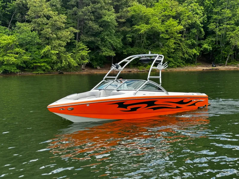 Slide: The Image of 2007 Centurion Avalanche boat with orange flame design on a lake. - 5