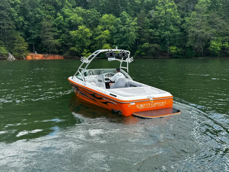 Slide: The Image of 2007 Centurion Avalanche boat on a lake, surrounded by lush green trees. - 6