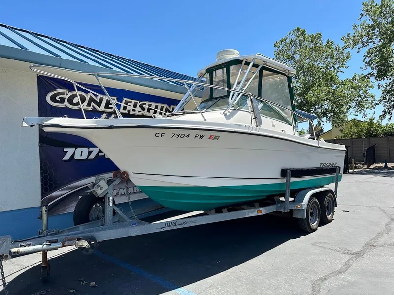 Slide: The Image of 2002 Trophy Walkaround boat on trailer, parked outside a fishing store. - 1