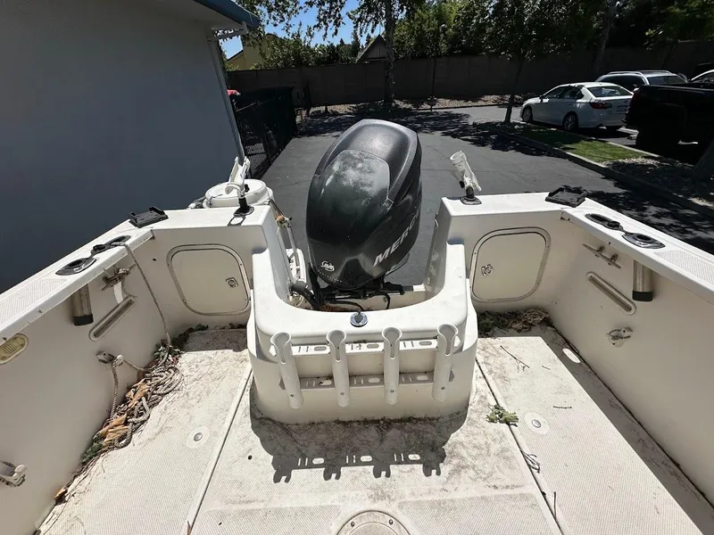 Slide: The Image of 2002 Trophy Walkaround boat with Mercury outboard motor, parked outdoors. - 10