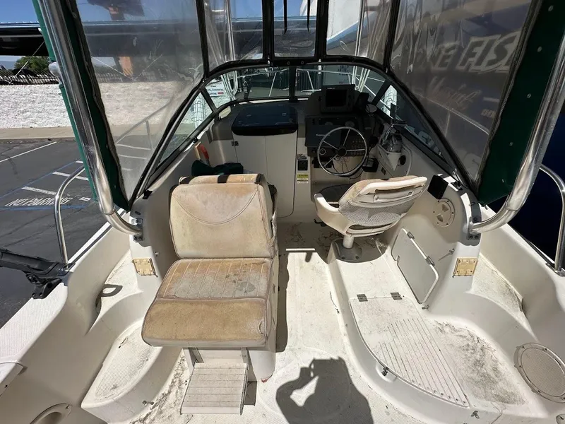 Slide: The Image of 2002 Trophy Walkaround boat interior with steering wheel and seating area. - 13