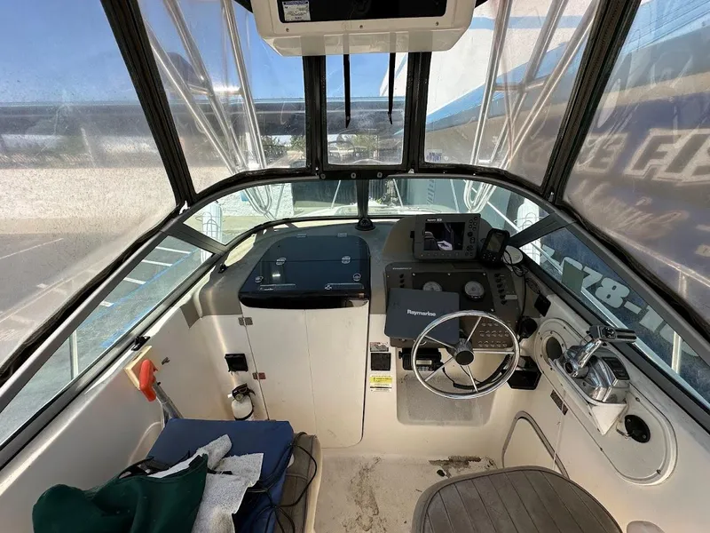 Slide: The Image of 2002 Trophy Walkaround boat cockpit with steering wheel and navigation equipment. - 16