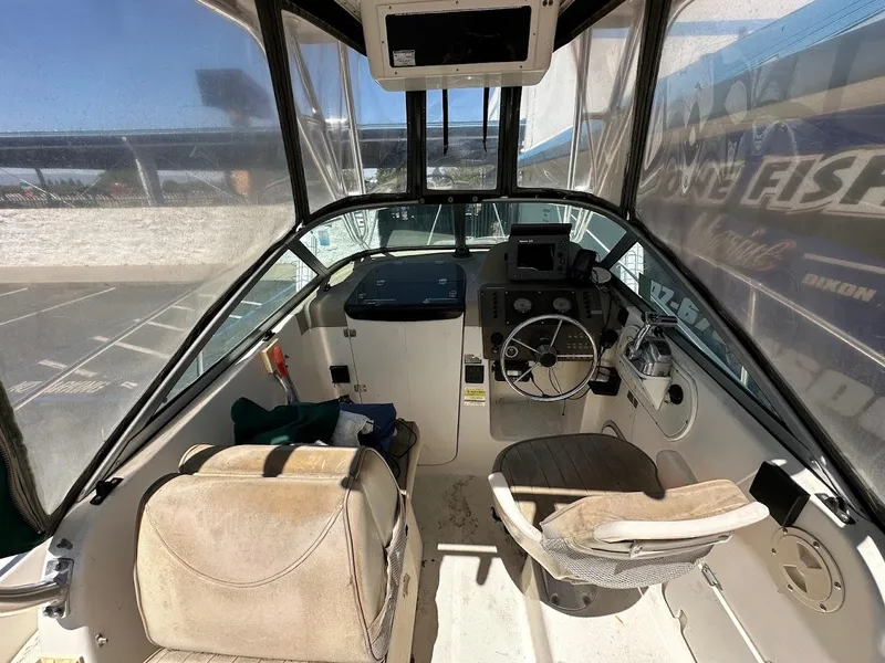 Slide: The Image of Interior view of a 2002 Trophy Walkaround boat cockpit with steering wheel and seating. - 17
