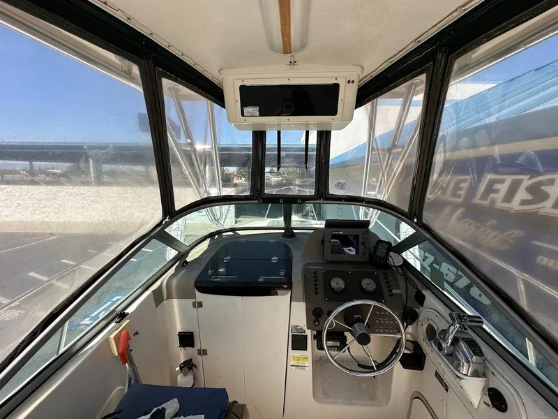 Slide: The Image of 2002 Trophy Walkaround boat interior with steering wheel and control panel. - 18