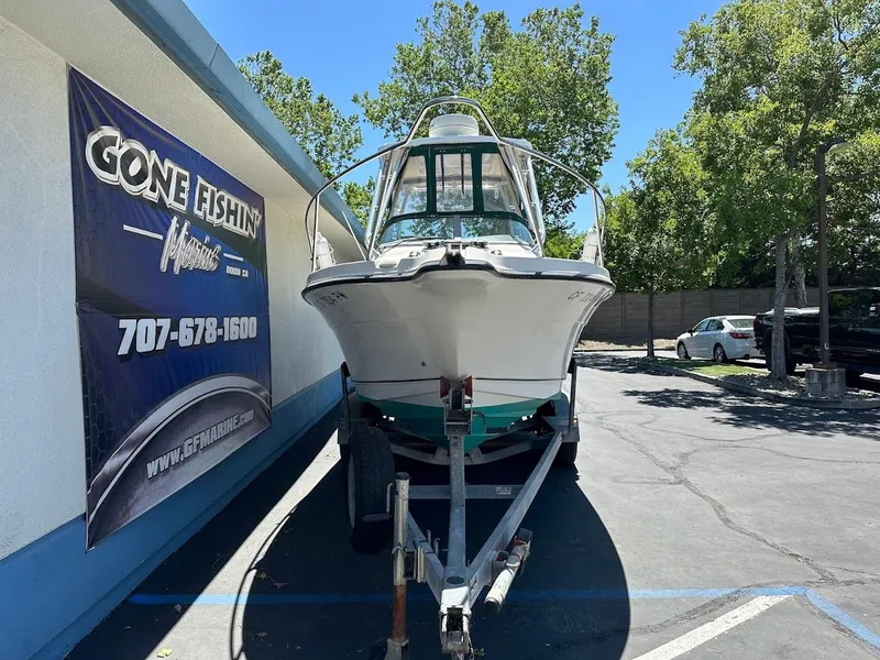 Slide: The Image of 2002 Trophy Walkaround boat on trailer outside Gone Fishin' Marine dealership. - 2