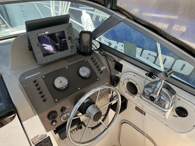 Slide: The Image of Control panel of a 2002 Trophy Walkaround boat with steering wheel and navigation equipment. - 20