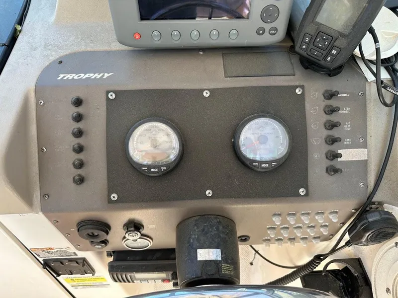 Slide: The Image of Control panel of a 2002 Trophy Walkaround boat with gauges and electronic devices. - 22