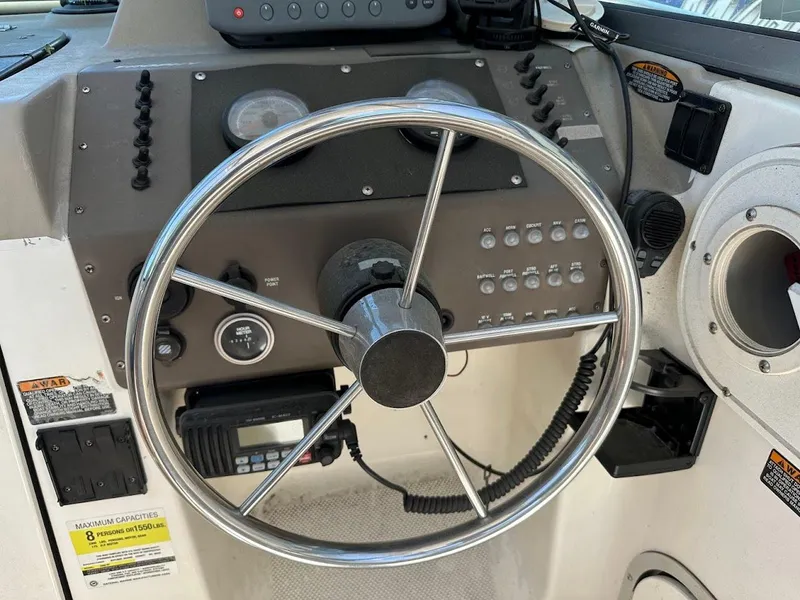 Slide: The Image of Steering wheel and dashboard of a 2002 Trophy Walkaround boat. - 23