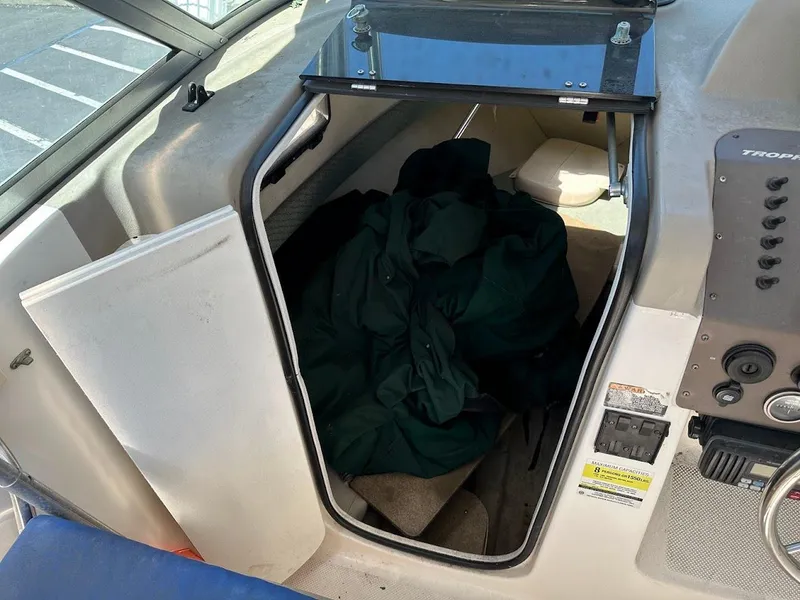 Slide: The Image of 2002 Trophy Walkaround cabin interior with storage space and control panel. - 26