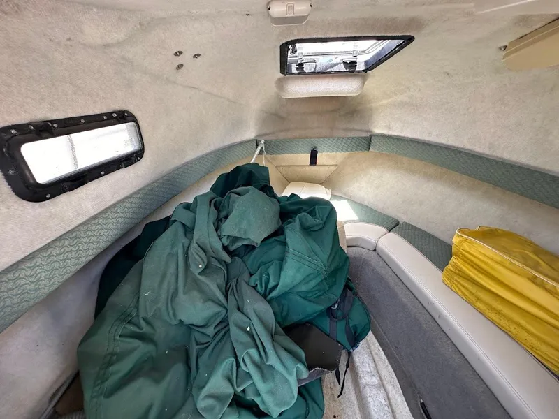 Slide: The Image of Interior cabin of a 2002 Trophy Walkaround boat with green and yellow gear. - 28