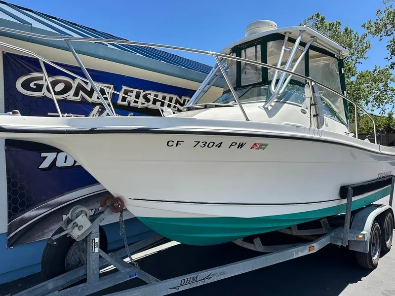 Slide: The Image of 2002 Trophy Walkaround boat on trailer, displayed outdoors with "Gone Fishing" sign. - 5