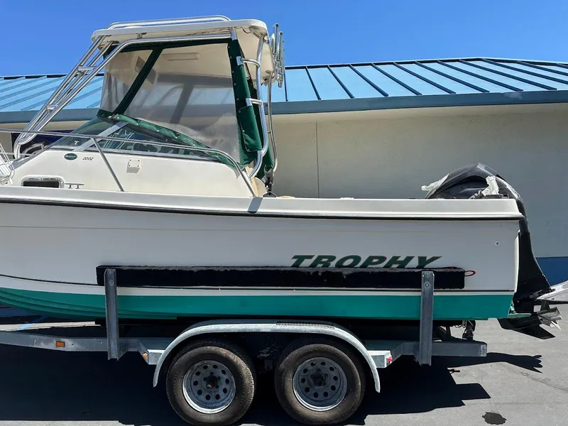 Slide: The Image of 2002 Trophy Walkaround boat on trailer, parked outdoors under blue sky. - 6
