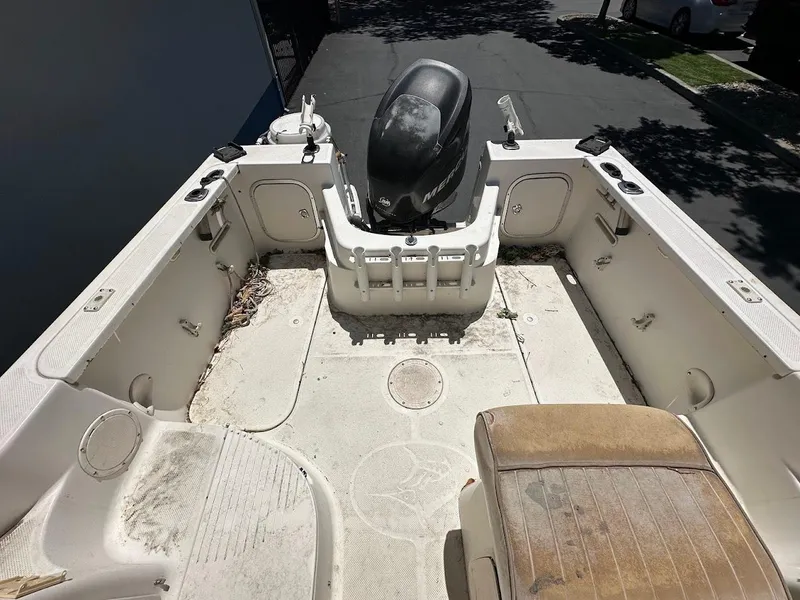 Slide: The Image of 2002 Trophy Walkaround boat interior with motor, showing seating and storage areas. - 9