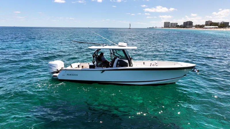 Slide: The Image of 2020 Blackfin 332 CC boat on clear blue ocean near coastline. - 0