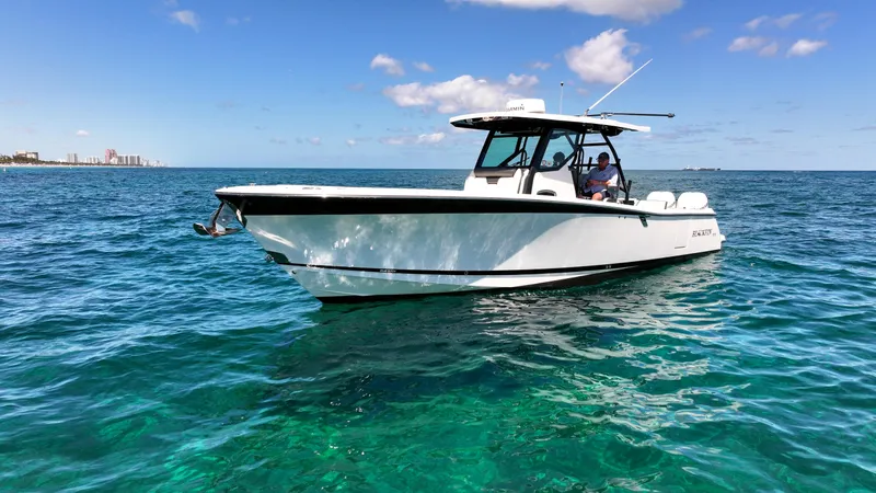 Slide: The Image of 2020 Blackfin 332 CC boat cruising on clear blue ocean waters under a sunny sky. - 3