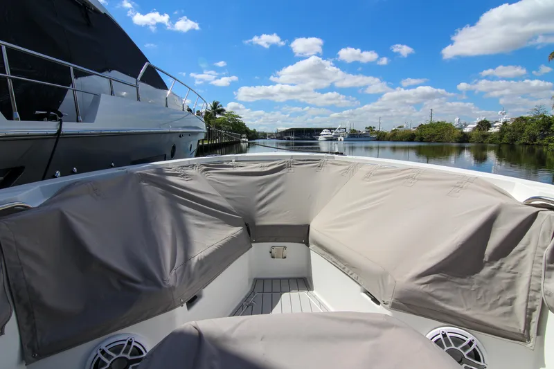 Slide: The Image of 2020 Blackfin 332 CC boat with covered seating, docked on a sunny day. - 40