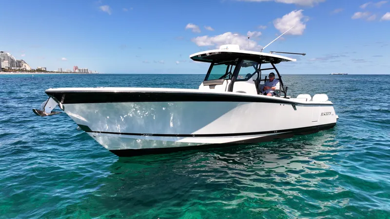Slide: The Image of 2020 Blackfin 332 CC boat on clear blue water under a sunny sky. - 5