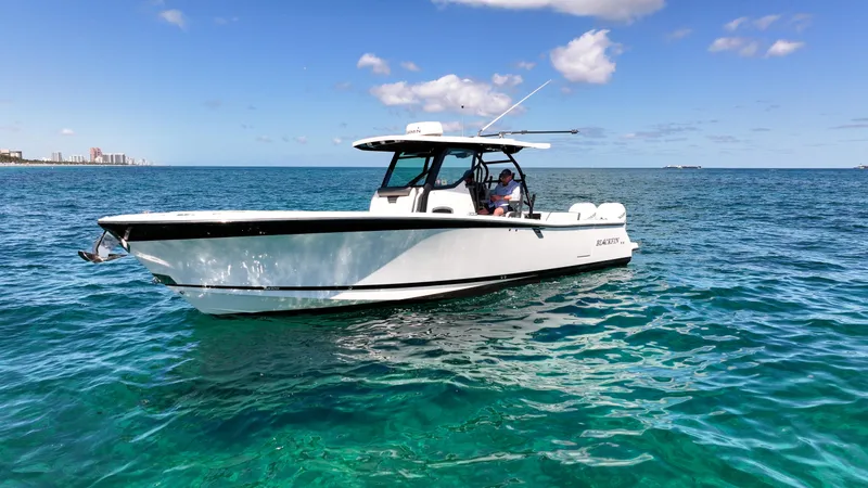 Slide: The Image of 2020 Blackfin 332 CC boat on clear blue ocean under sunny sky. - 6